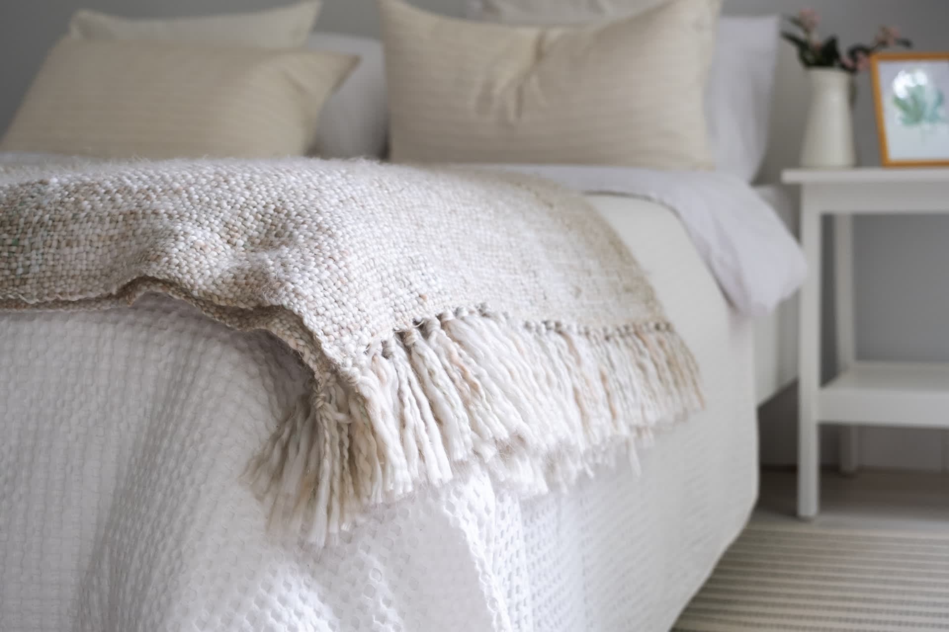 Cama con sábanas blancas y manta de punto, ropa de cama a medida en Lugo